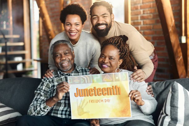 A joyful image of a Black family or friend group at a Juneteenth celebration
