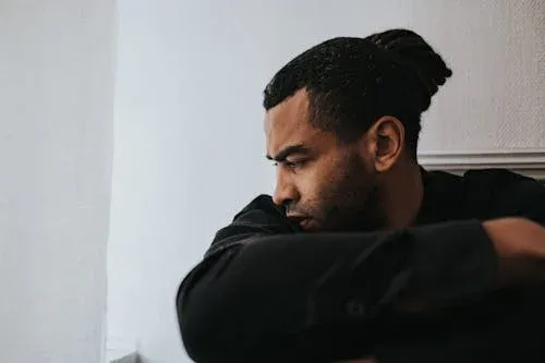 Young Depressed Black Man Staring at the Floor