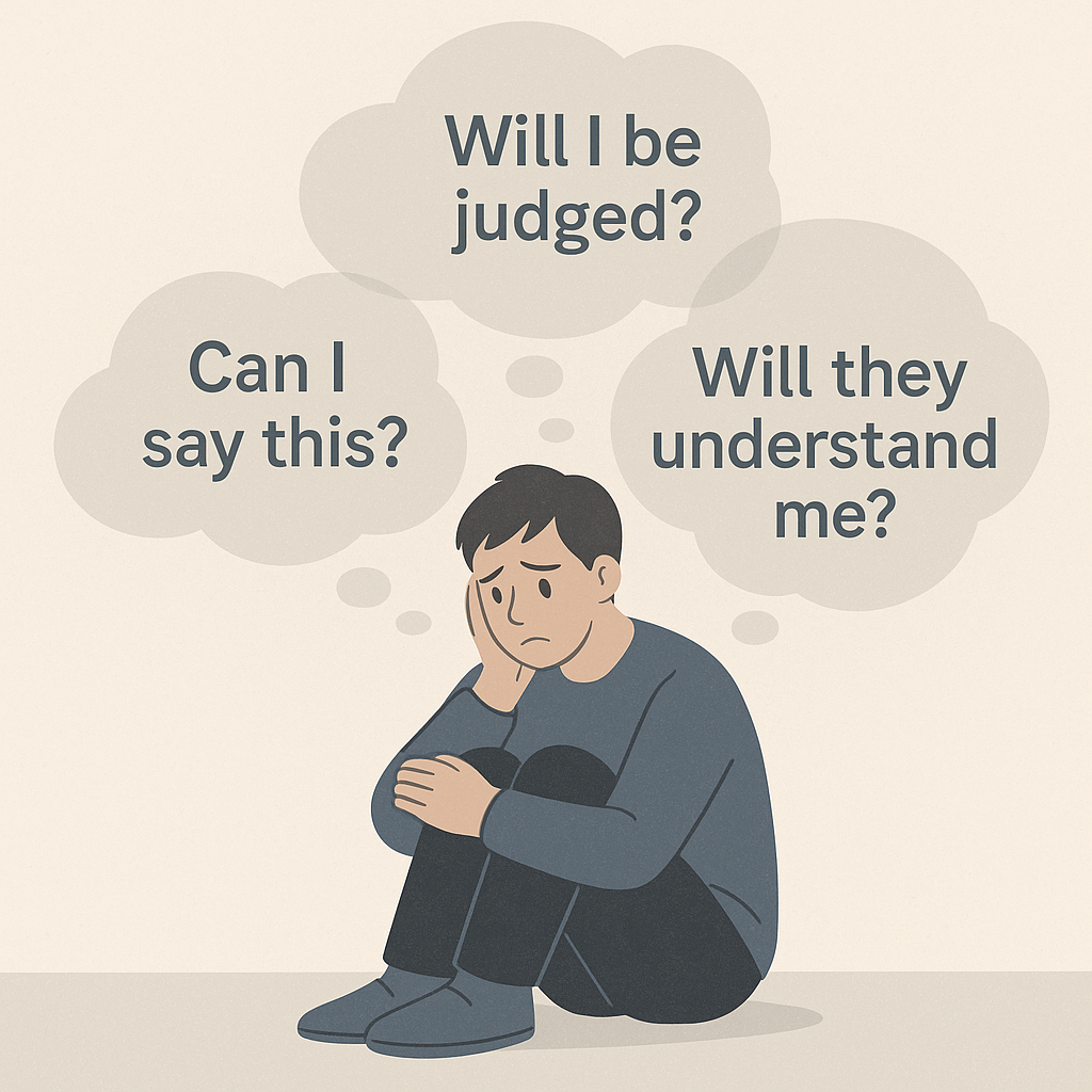A person sitting alone, visibly anxious, with faint overlapping “thought bubbles” showing phrases like “Will I be judged?”, “Can I say this?”, “Will they understand me?